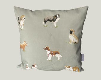 May include: A square, sage green throw pillow featuring watercolor illustrations of various dog breeds. The dogs are depicted in different poses, with a few standing and others lying down. The pillow has a soft, inviting appearance.