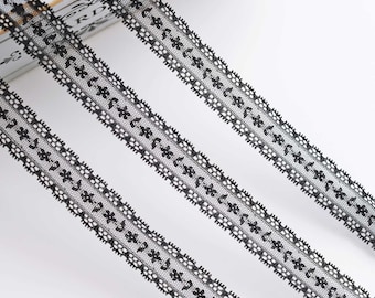 May include: Three pieces of black lace trim with a delicate floral pattern.