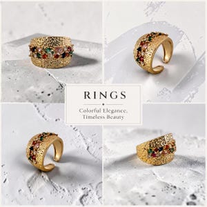 Könnte beinhalten: Ein goldfarbener Ring mit einer texturierten, gehämmerten Oberfläche und einem Mittelband aus mehrfarbigen, facettierten Steinen in Rot, Grün, Blau und klaren Tönen. Der Ring hat ein offenes Design, und das Bild enthält den Text RINGS Colorful Elegance, Timeless Beauty.