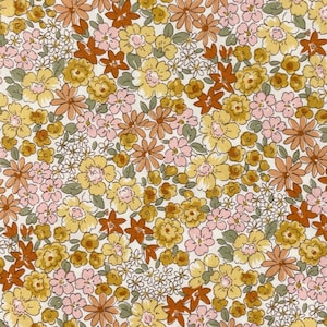 May include: A floral fabric featuring a dense pattern of various flowers in shades of yellow, pink, orange, and brown. The flowers are set against a white background, creating a vintage or cottagecore aesthetic. The design includes small, detailed blossoms.
