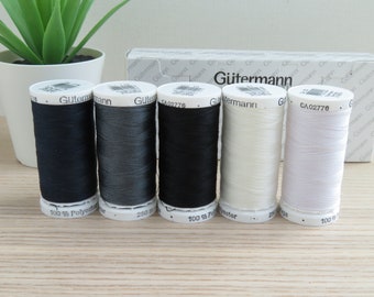 May include: Five spools of Gutermann thread in black, dark gray, light gray, off-white, and white. Each spool is labeled with the brand name and the text "100% Polyester".