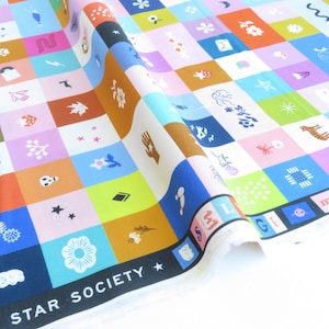 May include: A vibrant fabric featuring a grid of squares, each with a different illustration. The squares are in shades of blue, pink, orange, and green. The fabric is printed with the words "LUCKY STAR SOCIETY".