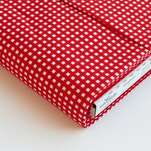 May include: Red and white gingham fabric with a small square pattern. The fabric is folded and the label reads "Riley Blake Designs Gingham C440 Pattern"