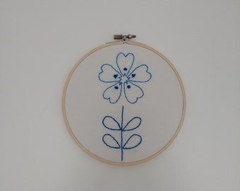 Minimalist blue embroidered flower, on embroidery hoop to hang