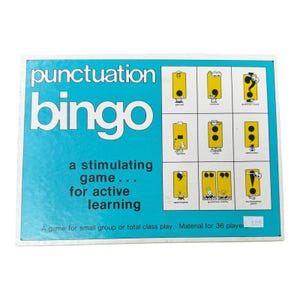 May include: A vintage punctuation bingo game with a blue background and white border. The game features a grid of punctuation marks and the words "punctuation bingo" in large white letters. The game is designed for active learning.