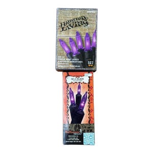 May include: Two boxes of Halloween string lights. The top box reads "Haunted Living" and contains 100 purple mini lights. The bottom box reads "50 ct BLACK" and features purple lights. Both boxes are for indoor/outdoor use.