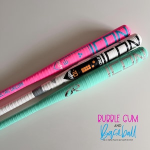 May include: Three baseball bats in pink, white, and teal. The pink bat has blue accents and the text "ELECTRIC UNICORN". The white bat has black and orange details and the text "-10 30 INCH". The teal bat has silver accents.