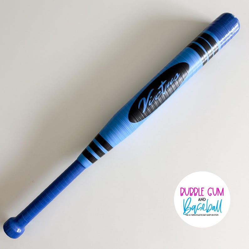 May include: A light blue baseball bat wrapped in blue and black tape. The bat features a black oval decal with the word Victus in blue script. A circular white logo in the corner displays the text Bubble Gum and Baseball The #1 Taped Plastic Bat Shop on Etsy.
