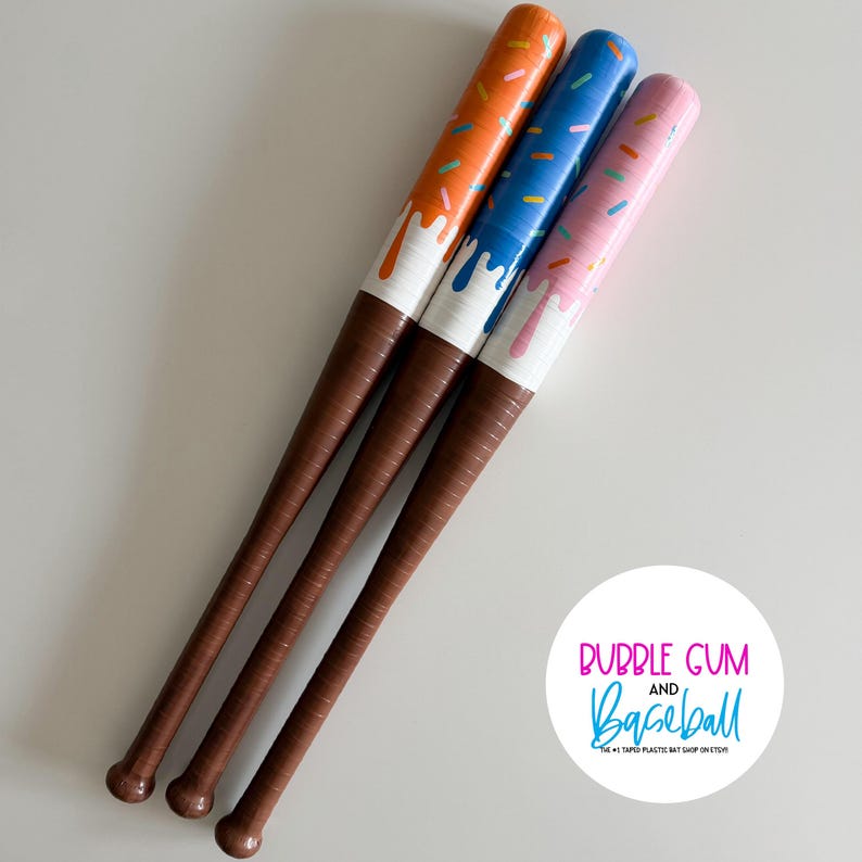 May include: Three baseball bats with brown handles and upper sections painted to resemble donuts with orange, blue, and pink frosting and colorful sprinkles. A circular white logo features the text BUBBLE GUM AND BASEBALL THE #1 TAPED PLASTIC BAT SHOP ON ETSY.