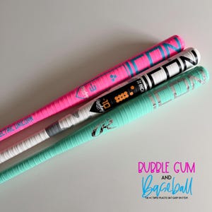 May include: Three baseball bats wrapped in colorful tape. The top bat is bright pink with blue text reading ELECTRIC UNICORN. The middle bat is white with black text and the Rawlings logo. The bottom bat is mint green with silver accents.