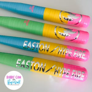 May include: Four colorful baseball bats with blue, green, yellow, and pink sections. The bats have the text "EASTON HYPE FIRE" in silver. The bats are arranged in a row, with the ends of the bats facing the viewer.