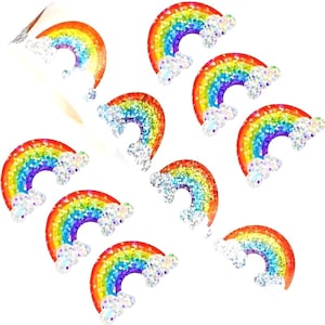 May include: A collection of rainbow-shaped stickers with glitter accents. Each sticker features a vibrant rainbow arc in shades of red, orange, yellow, green, blue, and purple, paired with fluffy white cloud embellishments. The stickers are arranged on a white background.