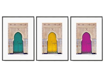 May include: Three framed prints of a decorative archway with a door in the center. The archway is decorated with intricate tile work. The door is a different color in each print: teal, yellow, and magenta.