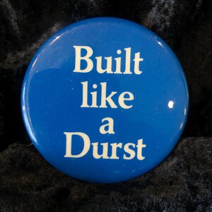 May include: A blue button with white text that reads "Built like a Durst".