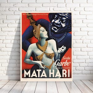Könnte beinhalten: Ein Vintage-Filmplakat für den Film "Mata Hari" mit Greta Garbo und Ramon Novarro. Das Plakat zeigt eine farbenfrohe Illustration von Garbo in einem glamourösen Kostüm, mit einer schattenhaften Figur hinter ihr. Der Text "Greta Garbo" und "Mata Hari" ist in fetter, weißer Schrift prominent dargestellt.