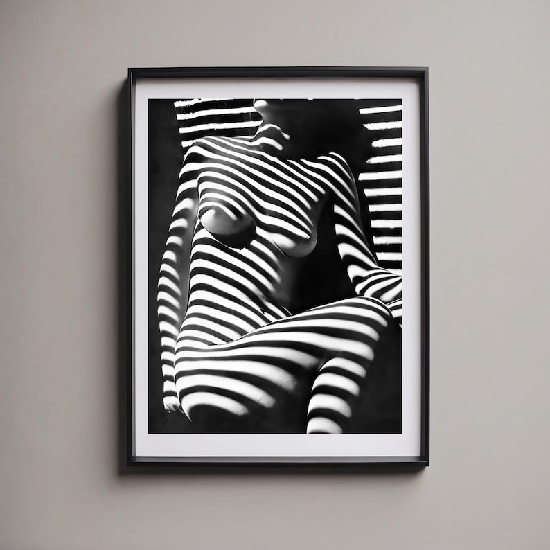 May include: Black and white photograph of a person's body with striped shadows cast on it.