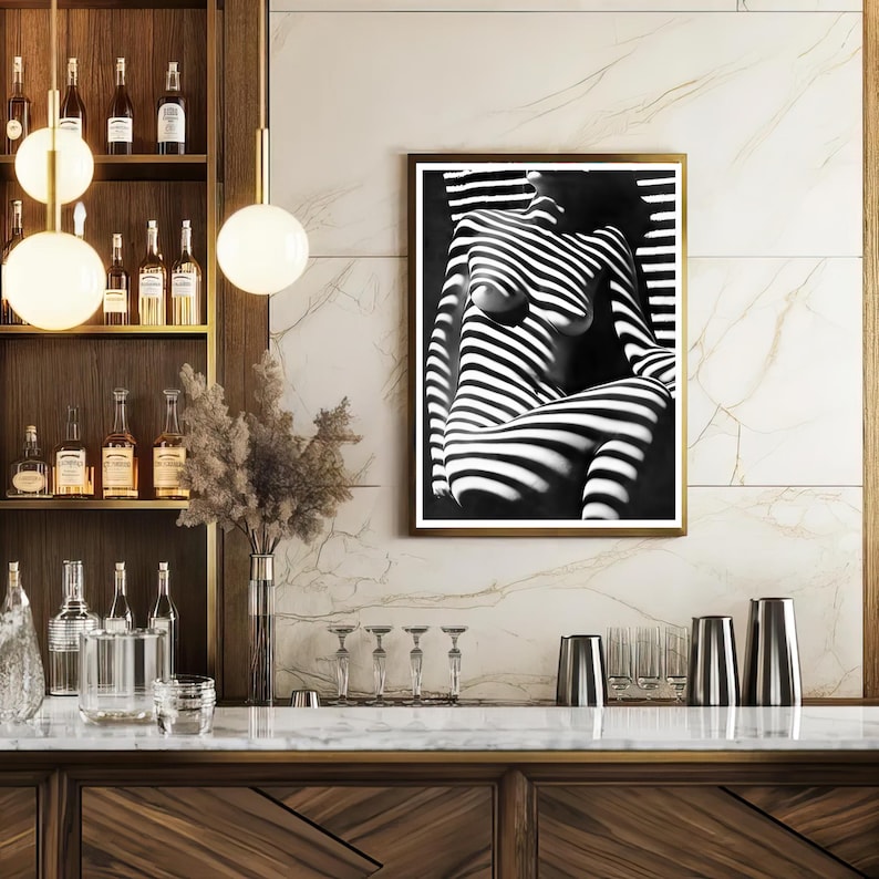 May include: Black and white photo of a person with light and shadow stripes, framed in a gold frame.
