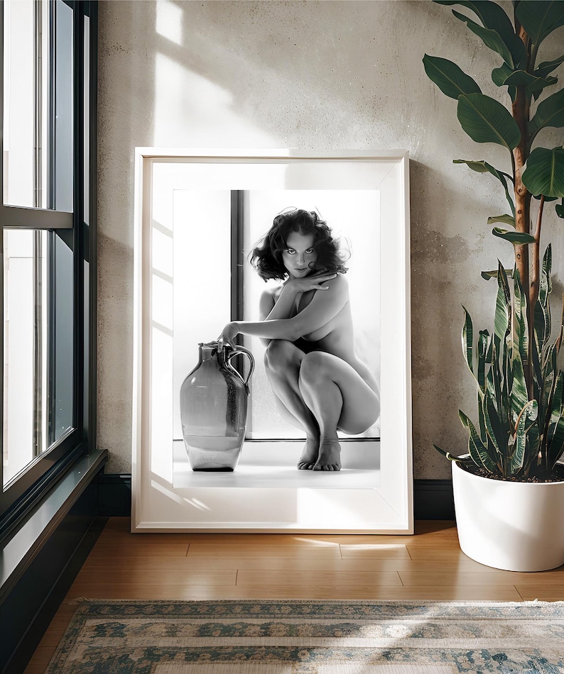 May include: A black and white photograph of a woman sitting on a windowsill with a large ceramic jug. The woman is looking directly at the camera with a serious expression.