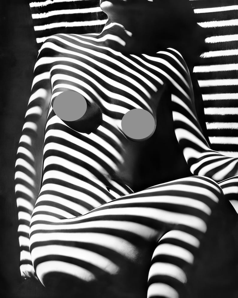 May include: Black and white photo of a person's body with stripes of light and shadow cast on it.