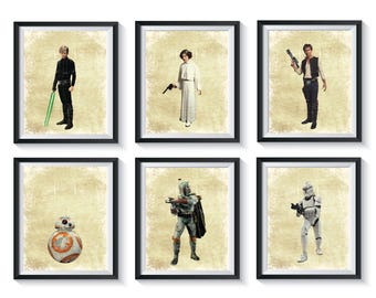May include: Six framed prints featuring characters from the Star Wars franchise. The prints are on a white background and each features a different character: Luke Skywalker, Princess Leia, Han Solo, Boba Fett, R2-D2, and a Stormtrooper.