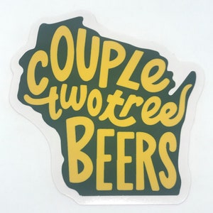 Może przedstawiać: Naklejka w kształcie stanu Wisconsin. Naklejka ma ciemnozielone tło z żółtym tekstem o treści "COUPLE two tree BEERS". Naklejka ma białą obwódkę.