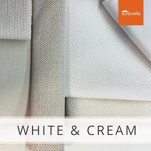 May include: Close-up of five fabric swatches in white and cream colors. The swatches have different textures and patterns. The bottom swatch has the text "WHITE & CREAM" printed on it. The top right swatch has the text "sunbrella" printed on it.