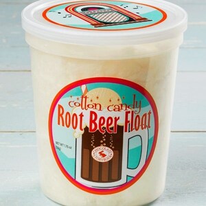 May include: A white plastic container filled with cotton candy, labeled "Cotton Candy Root Beer Float" with a retro jukebox design on the lid and a root beer float illustration on the front. The container is 1.75 oz.