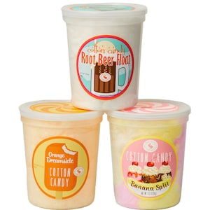 May include: Three clear plastic containers of cotton candy. The containers are stacked on top of each other. The top container has a white lid and a label that says "cotton candy Root Beer Float". The middle container has an orange lid and a label that says "Orange Dreamsicle Cotton Candy". The bottom container has a pink lid and a label that says "Cotton Candy Banana Split".