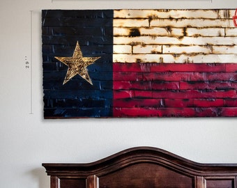 May include: A rustic wooden Texas flag with a distressed look. The flag is made of reclaimed wood and features the state of Texas's official colors: blue, white, and red. The flag is 60 inches wide and 29 inches tall.
