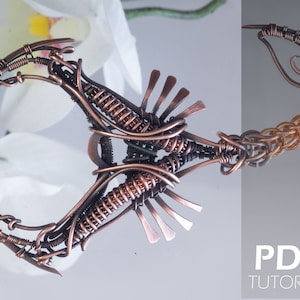 May include: A detailed wire sculpture of a scorpion, crafted with copper wire. The scorpion's tail is curled up, and its body is intricately woven with wire. The sculpture is set against a white background with a blurred image of a flower.
