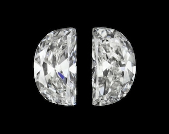 May include: Two brilliant-cut, half-moon shaped diamonds against a black background. The diamonds are clear and faceted, reflecting light. The gemstones are positioned side-by-side, showcasing their symmetrical shape and sparkle. Ideal for jewelry design.