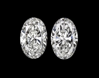 May include: Two oval-shaped diamonds, each with a brilliant cut, are shown against a black background.