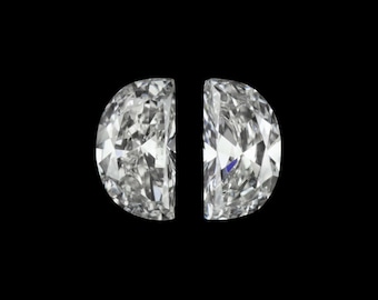 May include: Two half-round, clear, faceted gemstones, set side-by-side against a black background.