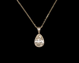 May include: A gold chain necklace with a pear-shaped diamond pendant.