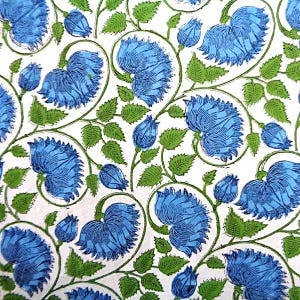 May include: A white fabric featuring a repeating pattern of vibrant blue flowers with layered petals and bright green serrated leaves on thin, curved stems. The design displays a dense, continuous botanical motif with various stages of flower blooms.