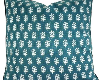 May include: Square teal throw pillow with a white leaf pattern. The pillow has a black border and a quilted appearance. The leaf design is evenly spaced across the fabric.