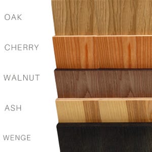 May include: Five wood samples stacked on top of each other. The wood types are labeled from top to bottom: Oak, Cherry, Walnut, Ash, and Wenge.