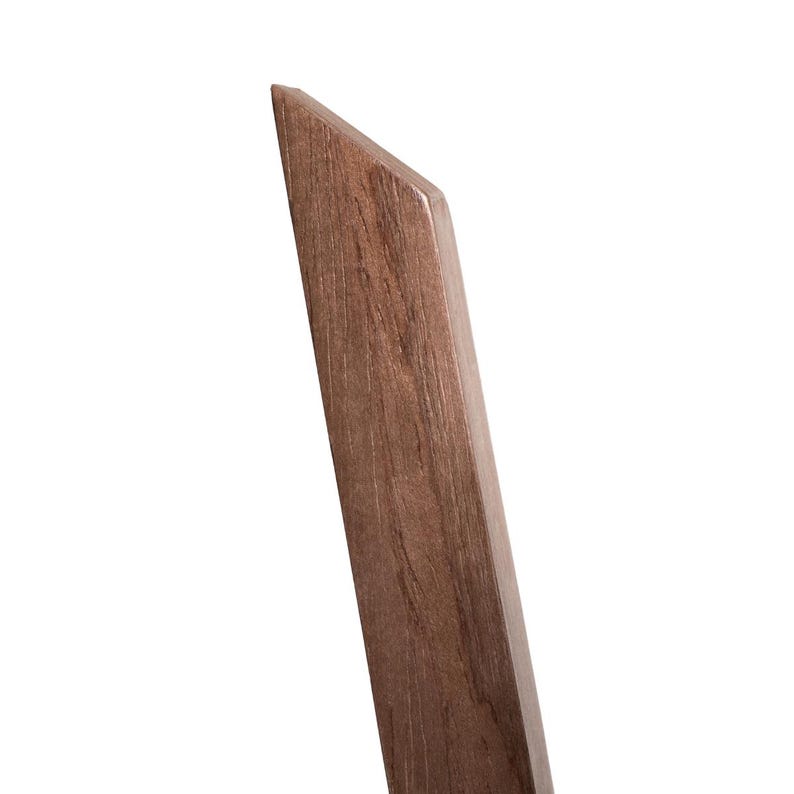 Close-up of walnut plant stand leg showing smooth curved silhouette and rich brown wood grain. Solid birch plywood with walnut veneer. Slim profile, approx. 2cm thick. Elegant handmade detail for plant lovers who appreciate natural materials.
