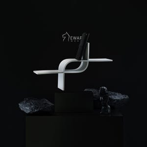 May include: A white, modern, curved wooden shelf with a black phone. The shelf has a unique design with a horizontal surface and a vertical section to hold the phone. The background is black, with a black box and rocks.