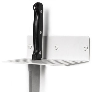 May include: White metal wall-mounted knife holder with a black knife inserted. The holder has a small shelf with slots for storing knives.