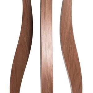 Detail shot of 3 curved walnut pillar legs of a tall indoor plant stand. Smooth hourglass shape, warm brown natural wood grain. Each leg approx. 2cm wide. Handmade birch plywood with walnut veneer finish. Unique sculptural flower pot stand.