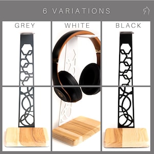 This image showcases three variations of the headphone stand, available in grey, white, and black, each featuring a different design cutout on the steel frame and a natural wood base.