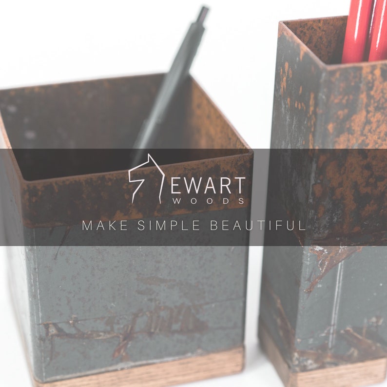Two rustic metal utensil holders with wooden bases, holding pens. The image features the logo Ewart Woods with the tagline Make Simple Beautiful