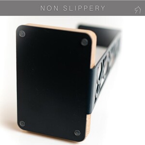Close-up of the headphone stand's non-slip base, featuring rubber pads for stability and protection.