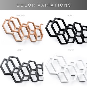 May include: A wall-mounted honeycomb-shaped rack shown in four color variations: natural wood, black, grey, and white. The text "COLOR VARIATIONS" appears at the top, with labels "WOODEN," "BLACK," "GREY," and "WHITE" above each respective rack design.