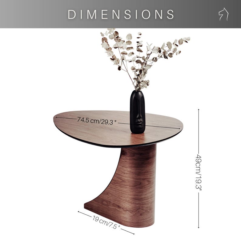 May include: A modern, brown wooden side table with a unique curved base. The table's oval top is 29.3 inches long and holds a black vase with dried flowers. The table is 19.3 inches high and 7.5 inches wide.