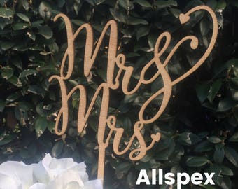 Wedding cake topper Reads: Mr & Mrs