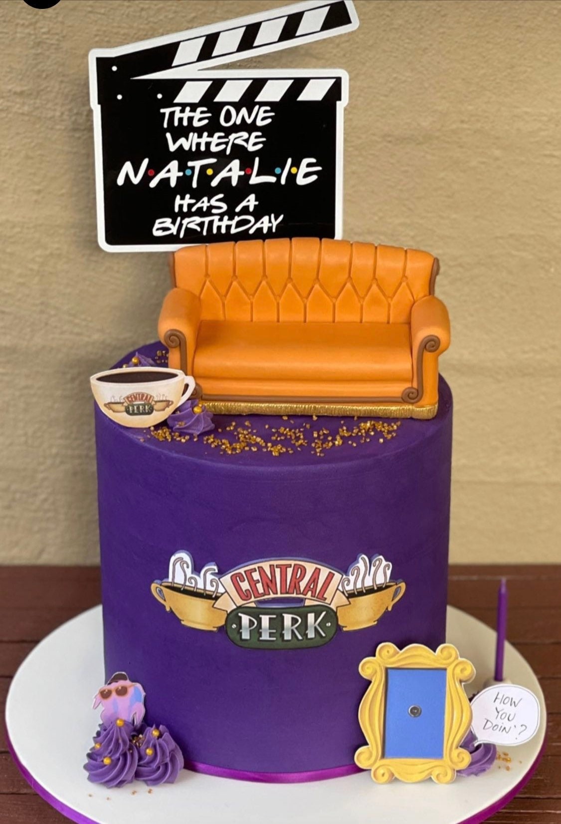 Friends theme clapperboard birthday cake topper reads The one where name has a birthday