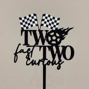 2nd Birthday racing theme cake topper reads: Two fast Two Curious