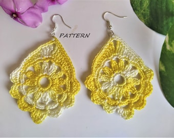 May include: A pair of handmade crochet earrings in a teardrop shape. The earrings feature a floral design with yellow and white yarn. The word "PATTERN" is visible in the image.